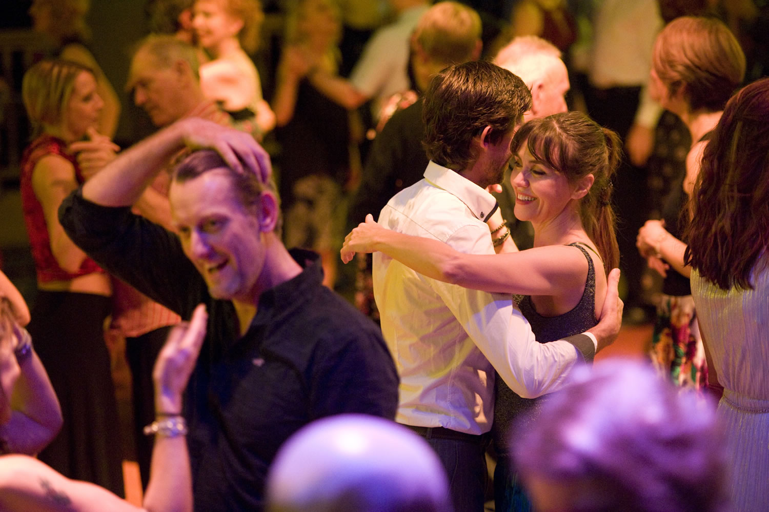 a milonga with couples on the dance floor